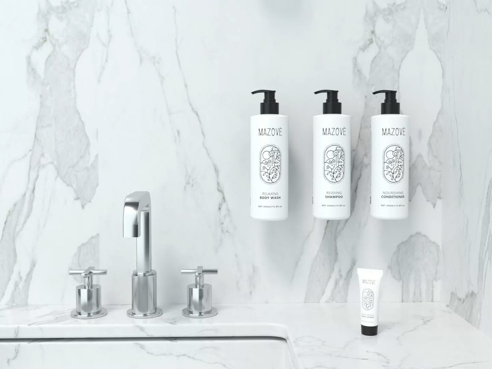Wall-mounted amenity dispensers on marble