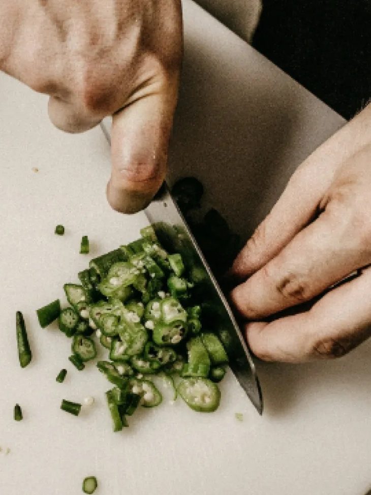 Chef chopping herbs on a board