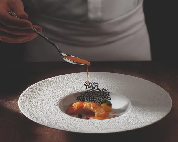 Sauce spooned onto a fine-dining plate